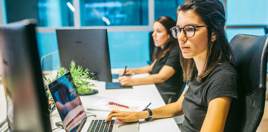 Our Design Team at work on their computers