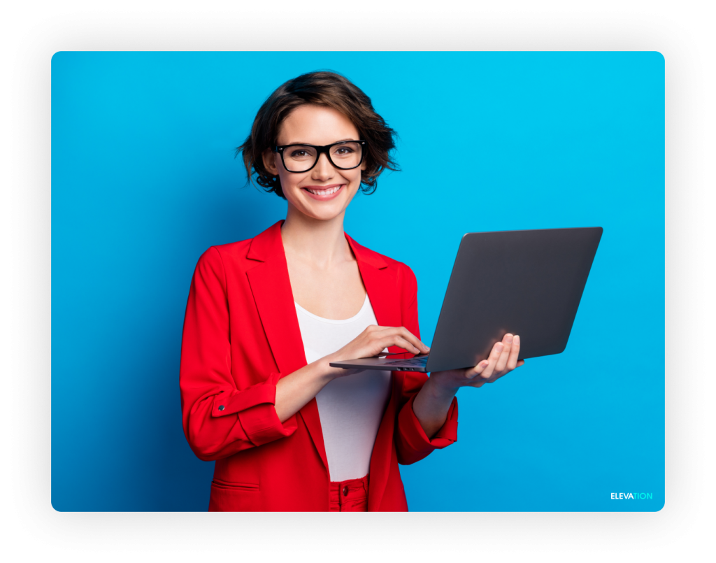 Elevation Female digital marketing professional holding a laptop