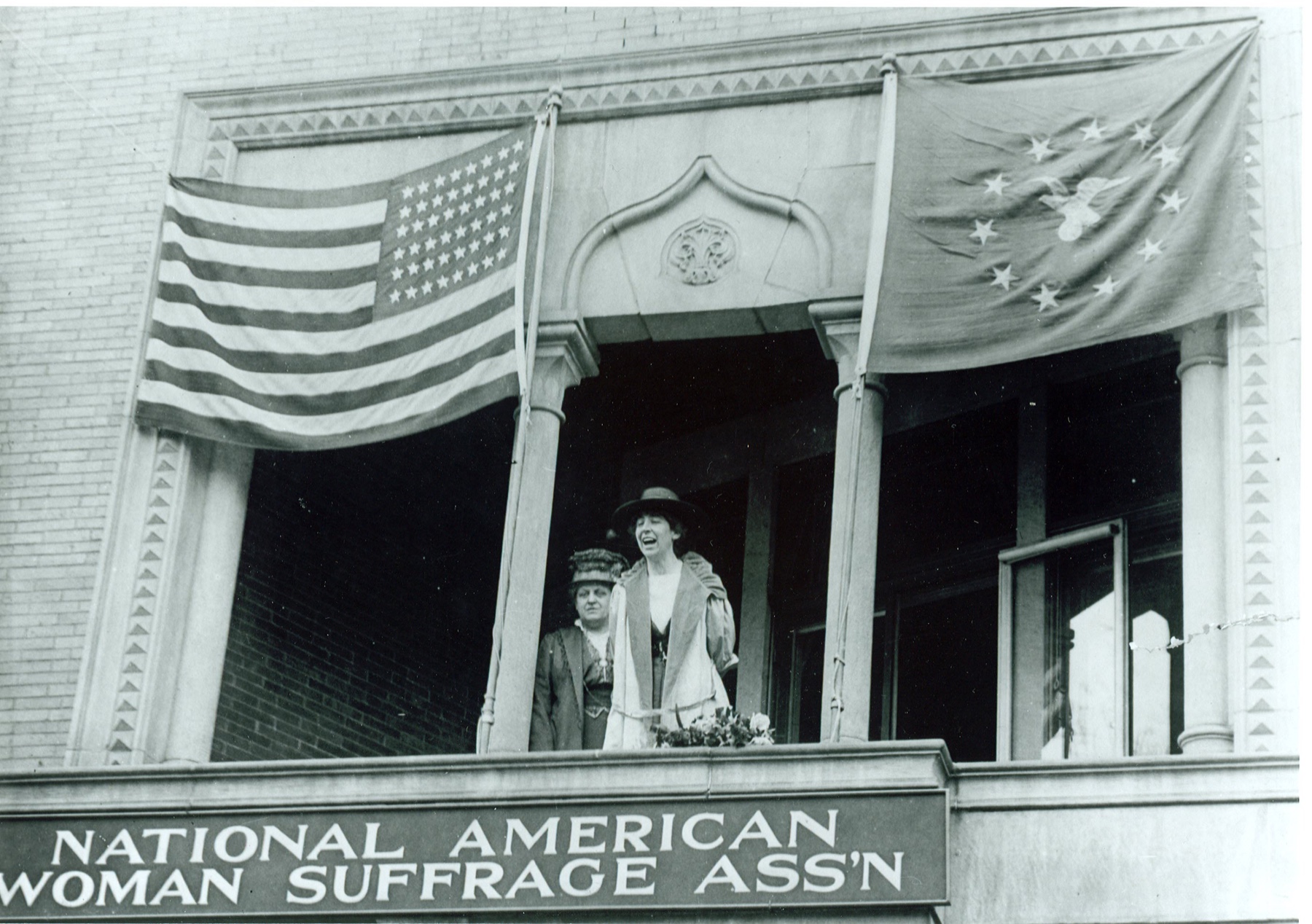 Jeannette Rankin addressing a crowd from the National American Woman Suffrage Association balcony, 1917