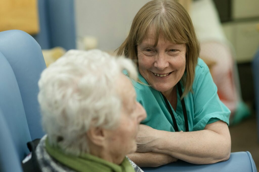 Community health worker smiling with an elderly patient