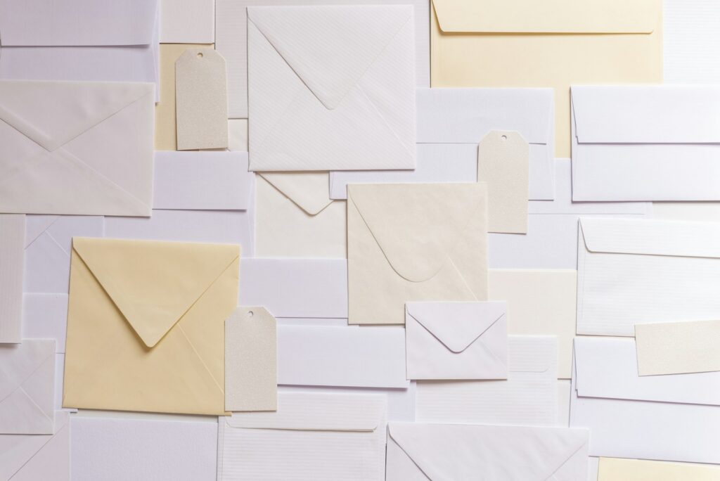 Flat lay of white and cream paper envelopes Elevation Flat lay of white and cream paper envelopes